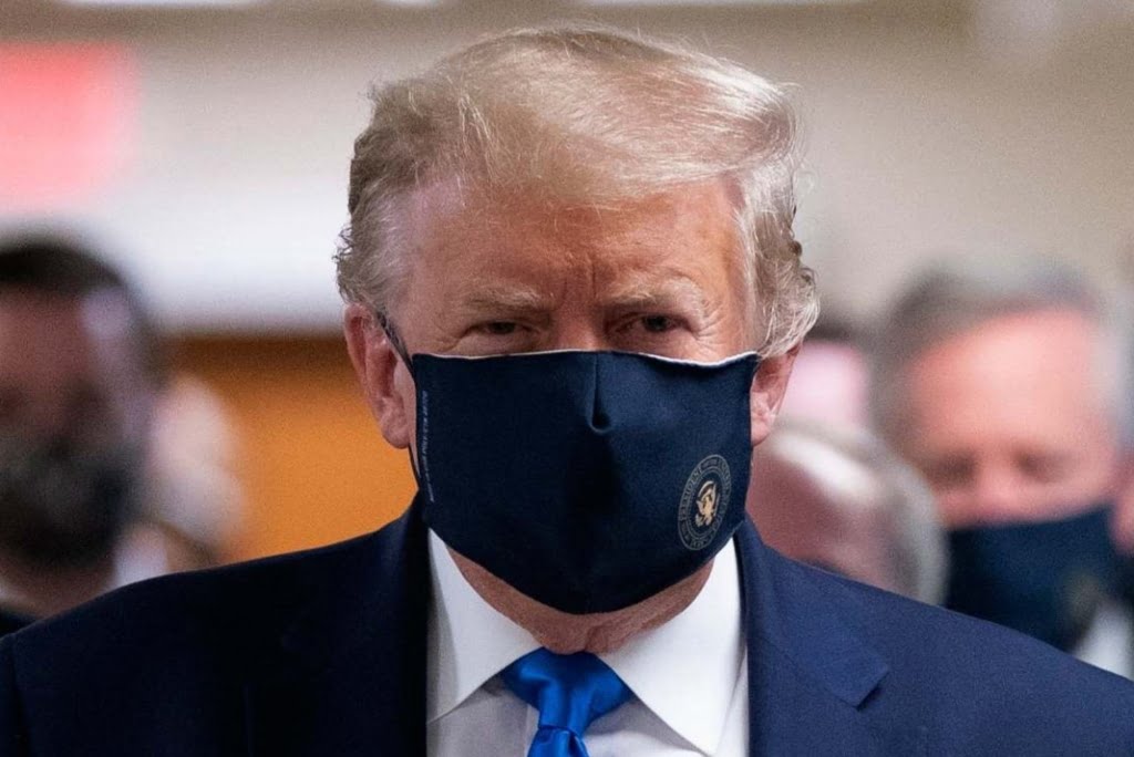 President Donald Trump wears a face mask